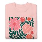 Botanica modern floral design with pink and coral blooms on a crewneck sweatshirt in pink, folded close-up of the design – Kate Spain design