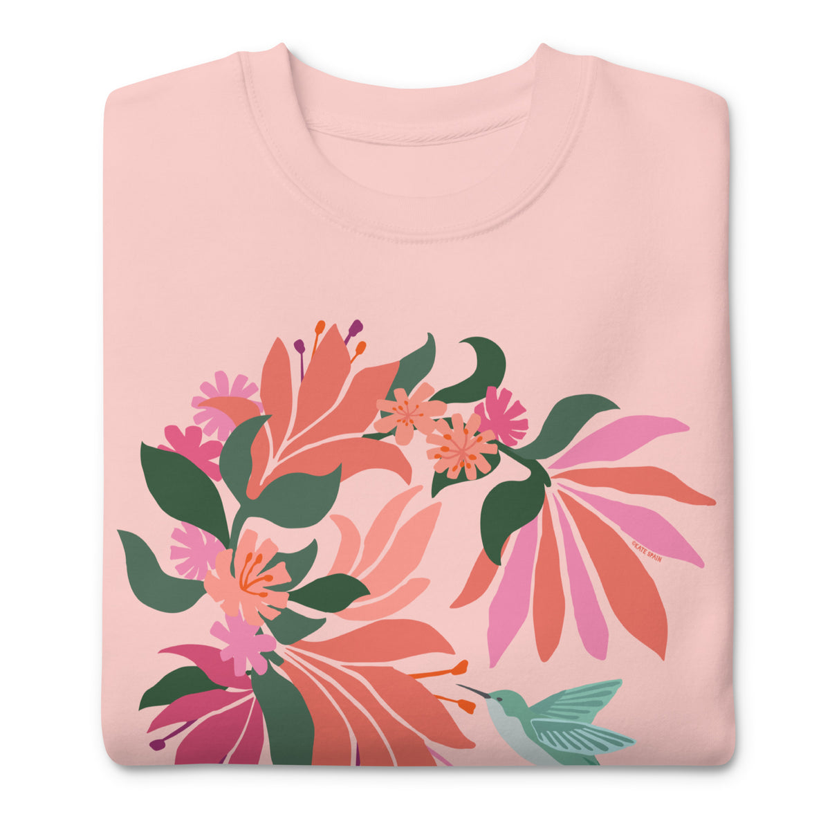 Hummingbird among coral tropical flowers on a crewneck sweatshirt in pink, folded close-up of the design – Kate Spain design