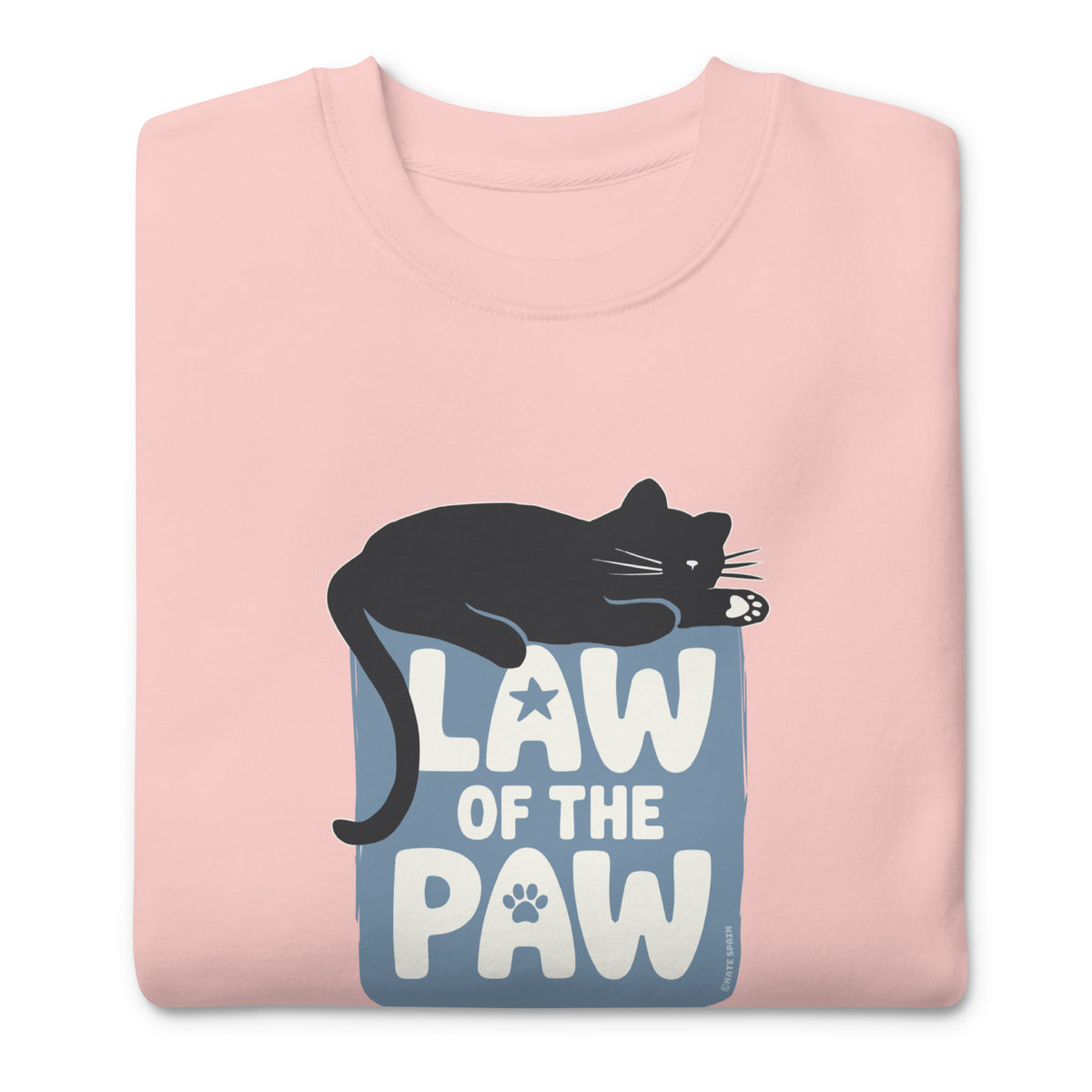 Law of the Paw® design with a cat napping on the logo on a crewneck sweatshirt in pink, folded close-up of the design – Kate Spain design