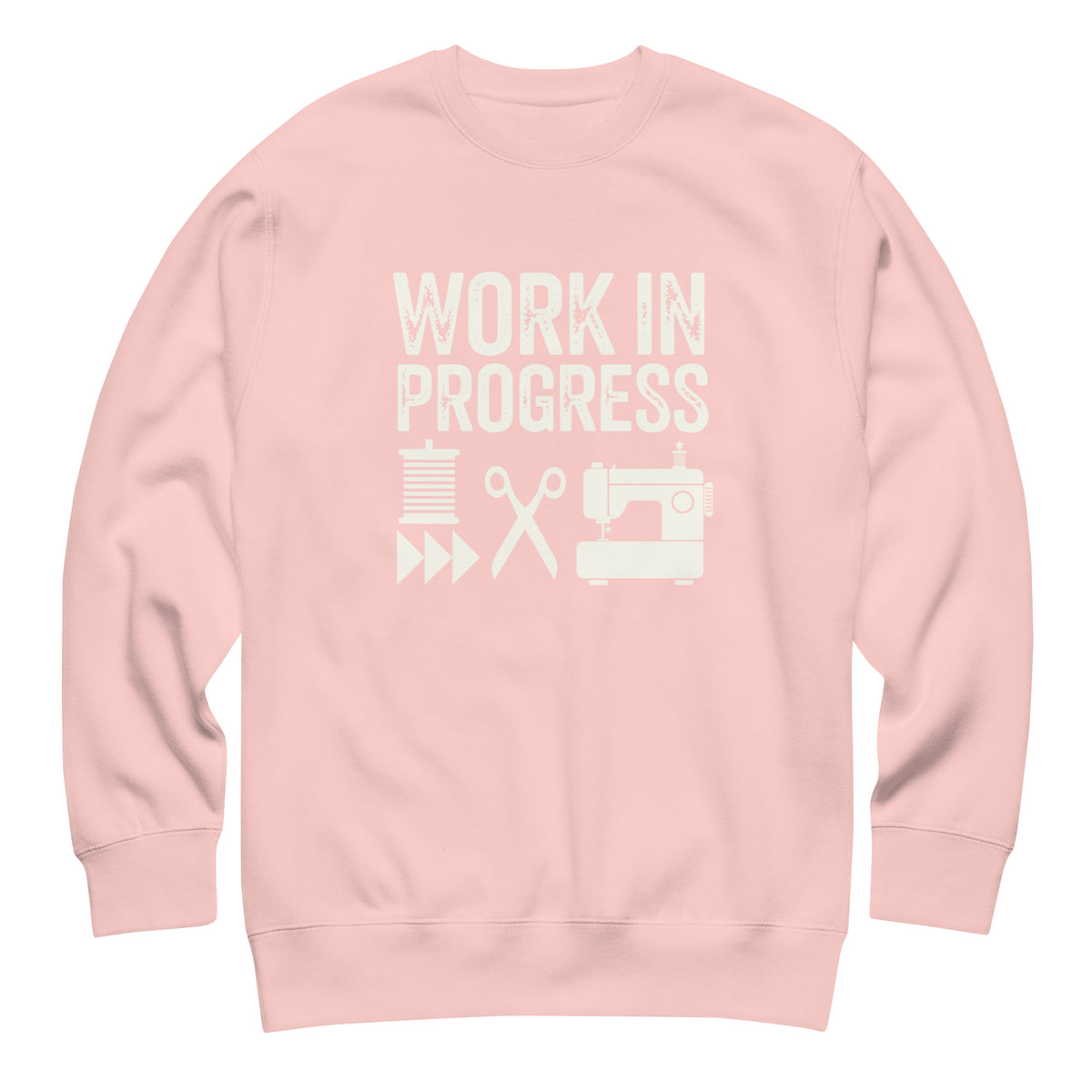 Work in Progress lettering with sewing icons on a premium sweatshirt in pink, front view – Kate Spain design for Pat Sloan