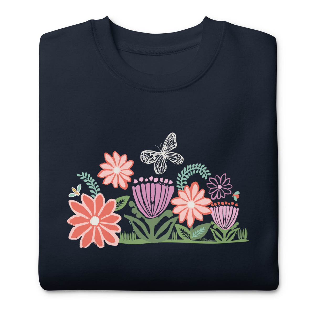 Bloom woodblock-style flowers with a butterfly, ladybug and bee on a crewneck sweatshirt in navy, folded close-up of the design – Kate Spain design