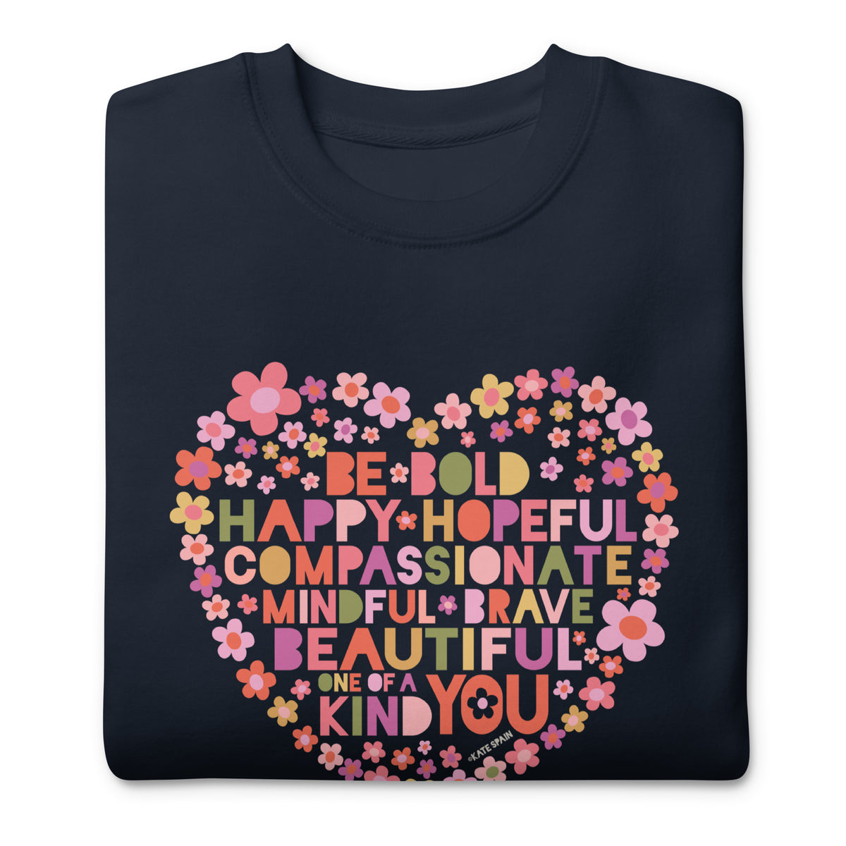 Be You floral heart of inspirational words on a premium sweatshirt in navy, folded close-up of the design – Kate Spain design