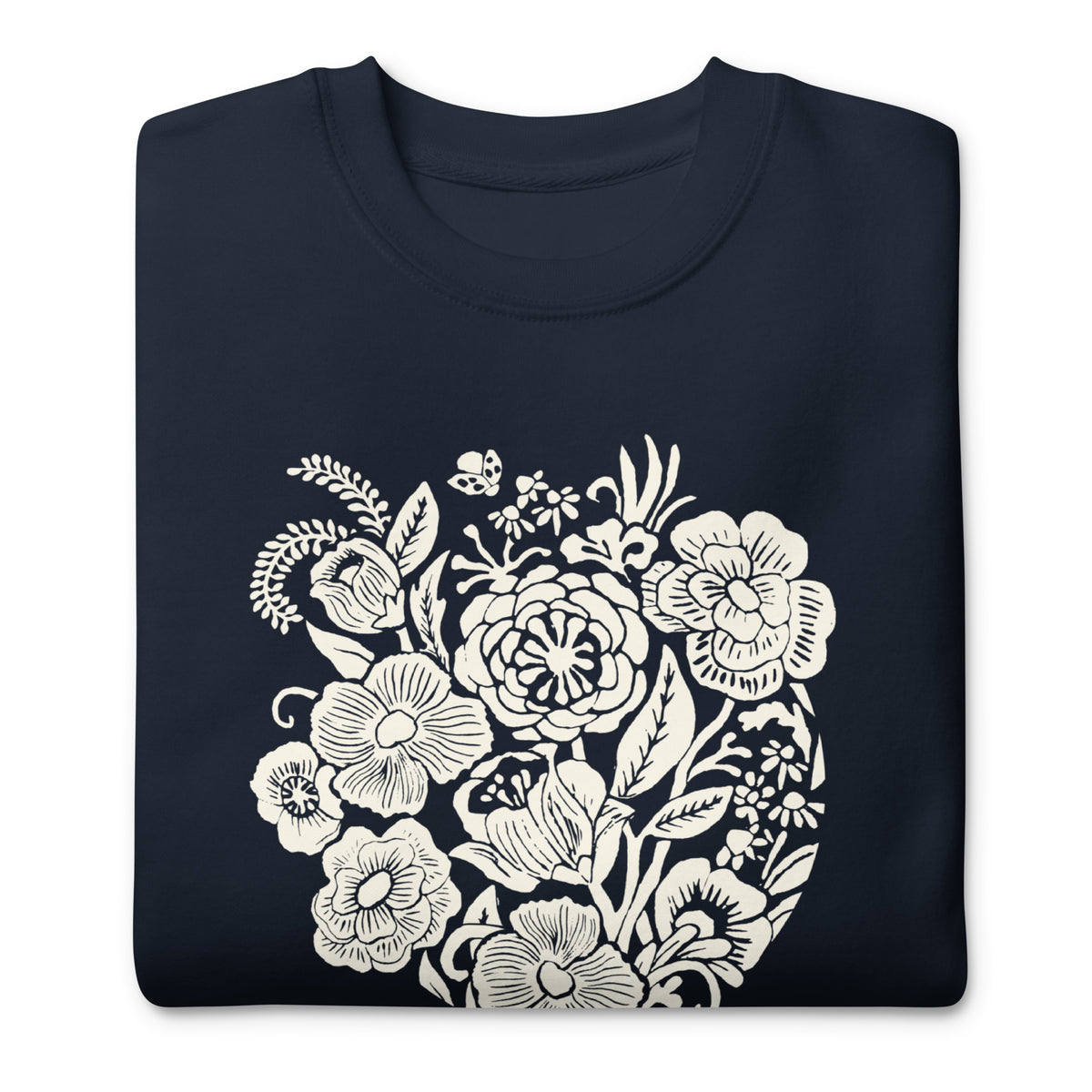 Meadowsweet woodblock-style bouquet of wildflowers on a crewneck sweatshirt in navy, folded close-up of the design – Kate Spain design