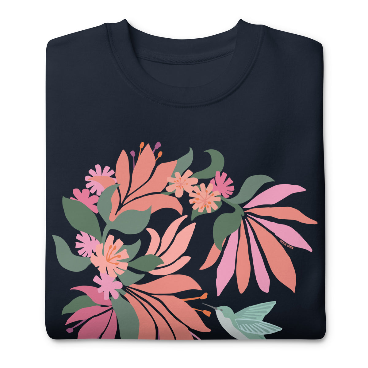 Hummingbird among coral tropical flowers on a crewneck sweatshirt in navy, folded close-up of the design – Kate Spain design