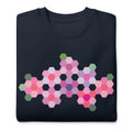 Pink GeoFlora hexagon flowers in pinks, mauves and sage on a crewneck sweatshirt in navy, folded close-up of the design – Kate Spain design for Pat Sloan