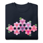 Pink GeoFlora hexagon flowers in pinks, mauves and sage on a crewneck sweatshirt in navy, folded close-up of the design – Kate Spain design for Pat Sloan