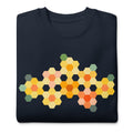 Yellow GeoFlora hexagon flowers in golden yellow, orange, coral and sage on a crewneck sweatshirt in navy, folded close-up of the design – Kate Spain design for Pat Sloan