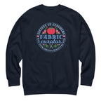 Fabric Curator Society of Stashers badge with a tomato pincushion on a crewneck sweatshirt in navy, front view – Kate Spain design for Pat Sloan