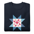 Liberty Love star quilt block with a heart in red, white and blue on a crewneck sweatshirt in navy, folded close-up of the design – Kate Spain design for Pat Sloan