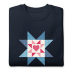 Liberty Love star quilt block with a heart in red, white and blue on a crewneck sweatshirt in navy, folded close-up of the design – Kate Spain design for Pat Sloan