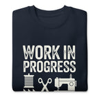 Work in Progress lettering with sewing icons on a premium sweatshirt in navy, folded close-up of the design – Kate Spain design for Pat Sloan