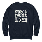 Work in Progress lettering with sewing icons on a premium sweatshirt in navy, front view – Kate Spain design for Pat Sloan