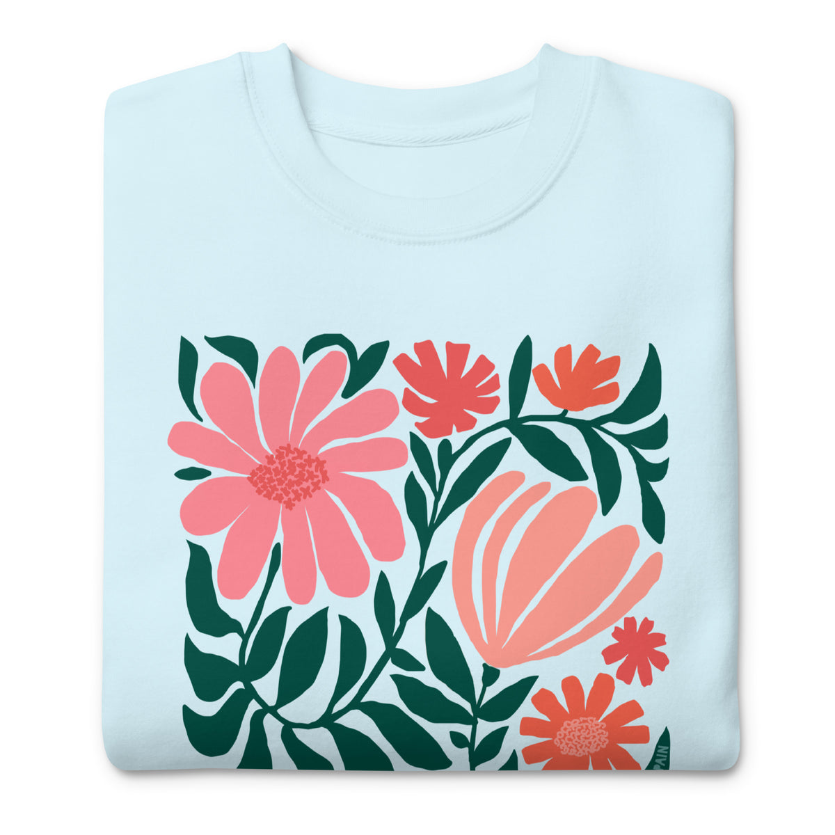 Botanica modern floral design with pink and coral blooms on a crewneck sweatshirt in sky blue, folded close-up of the design – Kate Spain design