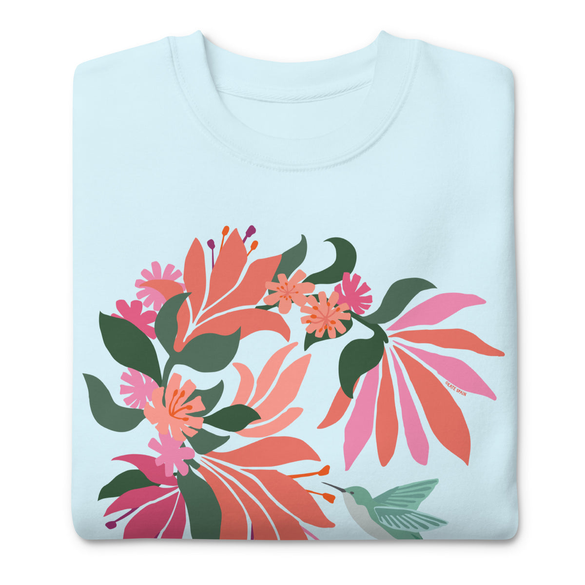 Hummingbird among coral tropical flowers on a crewneck sweatshirt in sky blue, folded close-up of the design – Kate Spain design