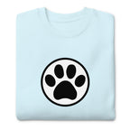 Law of the Paw® cat paw print on a crewneck sweatshirt in sky blue, folded close-up of the design – Kate Spain design