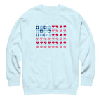 United We Quilt patchwork flag with quilt-block stars and heart stripes on a crewneck sweatshirt in sky blue, front view – Kate Spain design for Pat Sloan