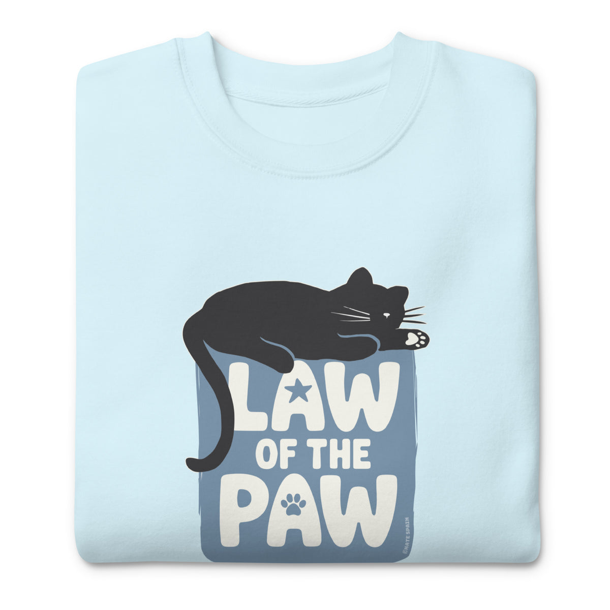 Law of the Paw® design with a cat napping on the logo on a crewneck sweatshirt in sky blue, folded close-up of the design – Kate Spain design