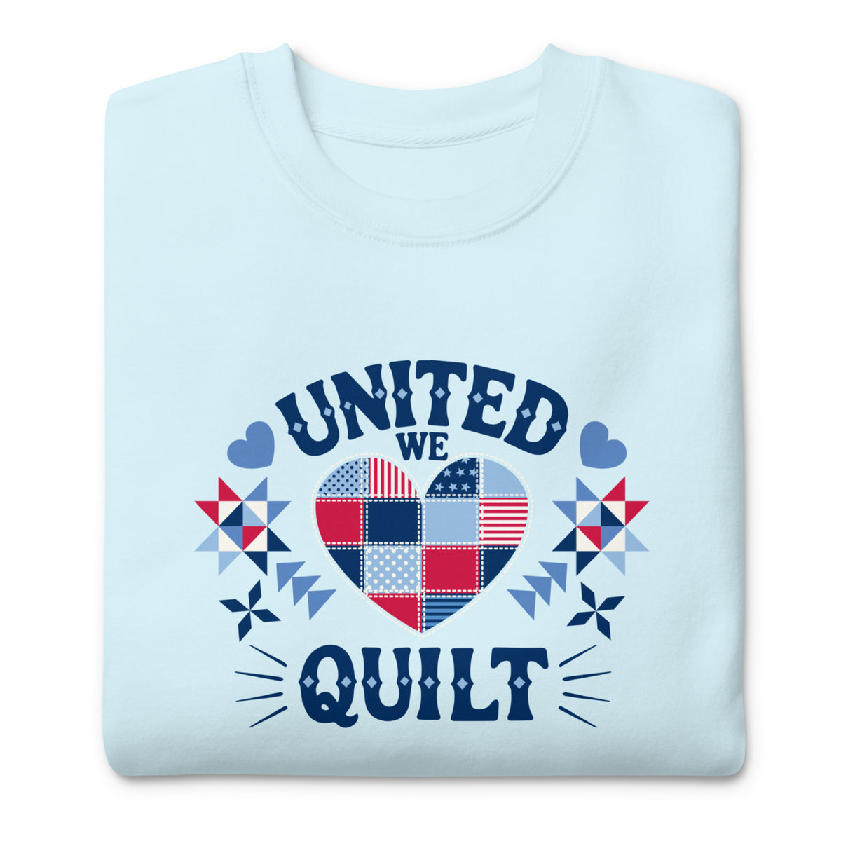 United We Quilt patchwork heart with quilt stars on a premium sweatshirt in sky blue, folded close-up of the design – Kate Spain design for Pat Sloan