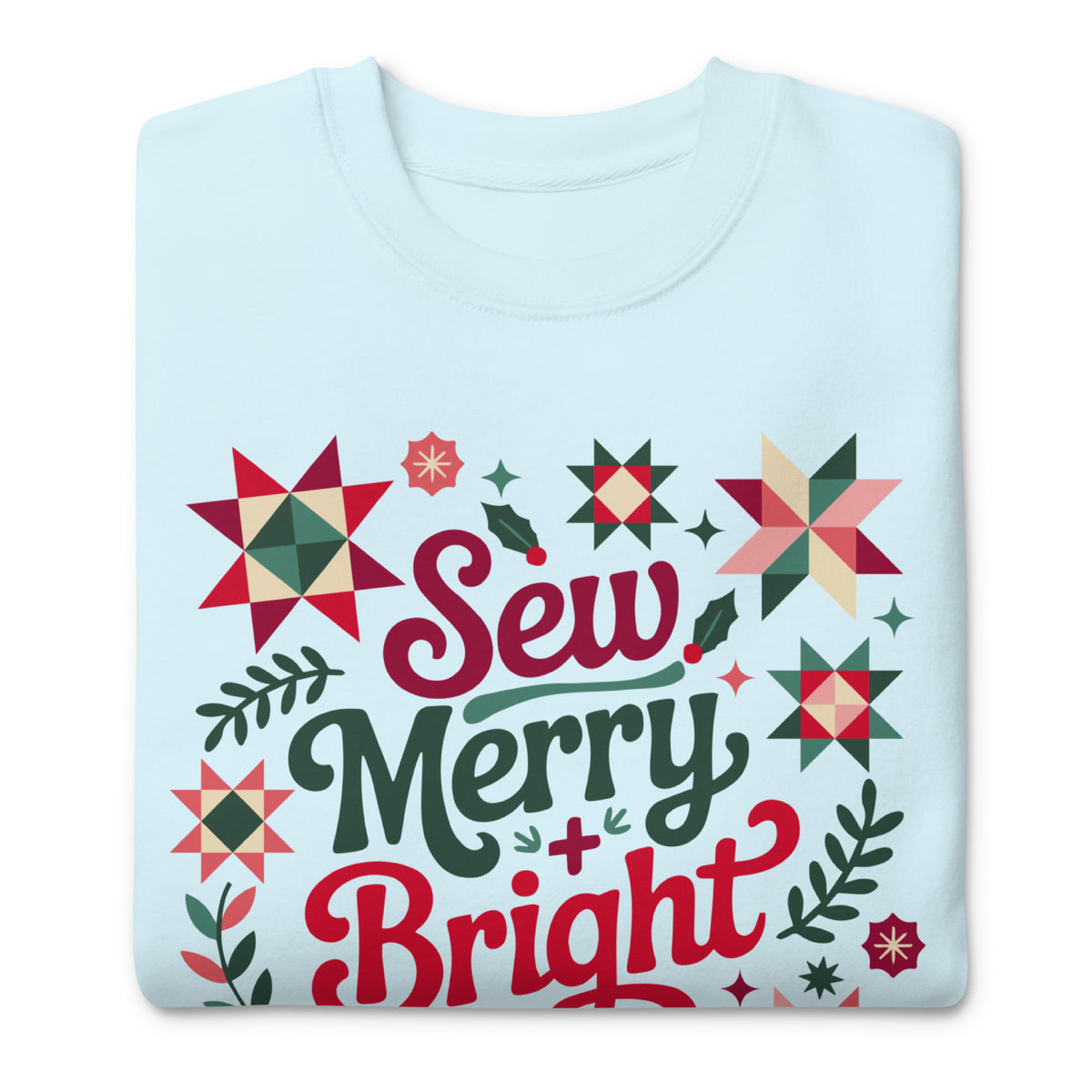 Sew Merry + Bright lettering with quilt stars and holly on a premium sweatshirt in sky blue, folded close-up of the design – Kate Spain design for Pat Sloan