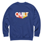 Moda QUILT logo with orange, pink, blue and yellow rays on a premium sweatshirt in royal blue, front view – Kate Spain design