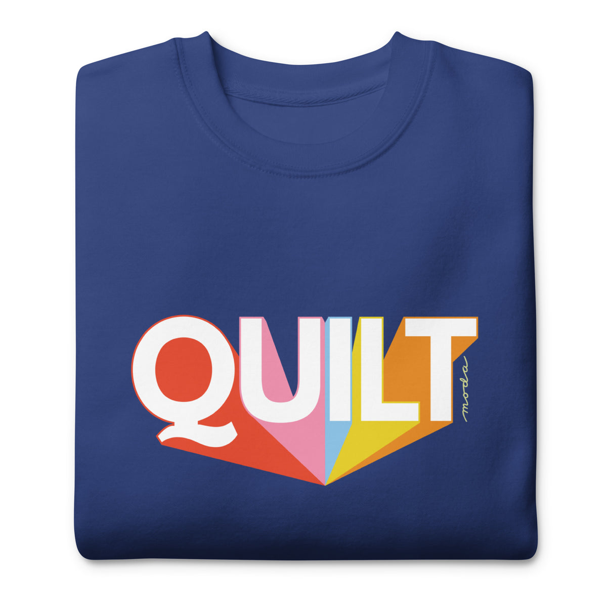 Moda QUILT logo with orange, pink, blue and yellow rays on a premium sweatshirt in royal blue, folded close-up of the design – Kate Spain design