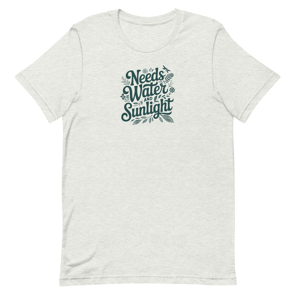 Needs Water + Sunlight hand lettering with leaf and sun accents on a t-shirt in ash, front view – Kate Spain design