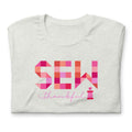 Sew Thankful patchwork lettering with a heart-topped thread spool on a t-shirt in ash, folded close-up of the design – Kate Spain design for Pat Sloan