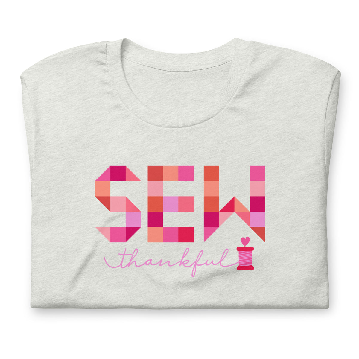 Sew Thankful patchwork lettering with a heart-topped thread spool on a t-shirt in ash, folded close-up of the design – Kate Spain design for Pat Sloan