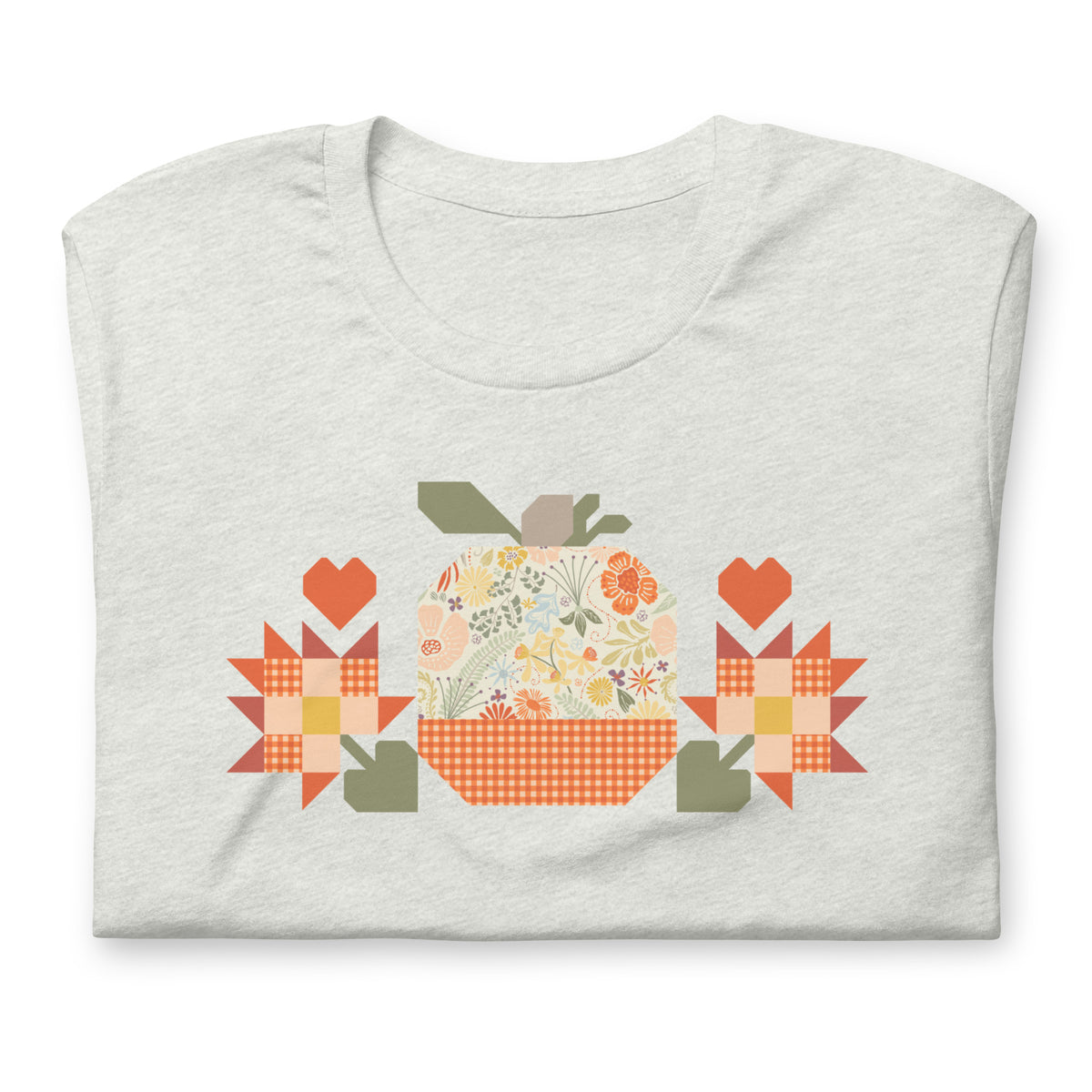Falling for Fall patchwork pumpkin with quilt-block stars and hearts on a t-shirt in ash, folded close-up of the design – Kate Spain design for Pat Sloan