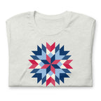 Barn Star quilt block in red, white and blue on a t-shirt in ash, folded close-up of the design – Kate Spain design for Pat Sloan