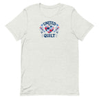 Quilters United quilt badge in red, white and blue on a t-shirt in ash, front view – Kate Spain design for Pat Sloan