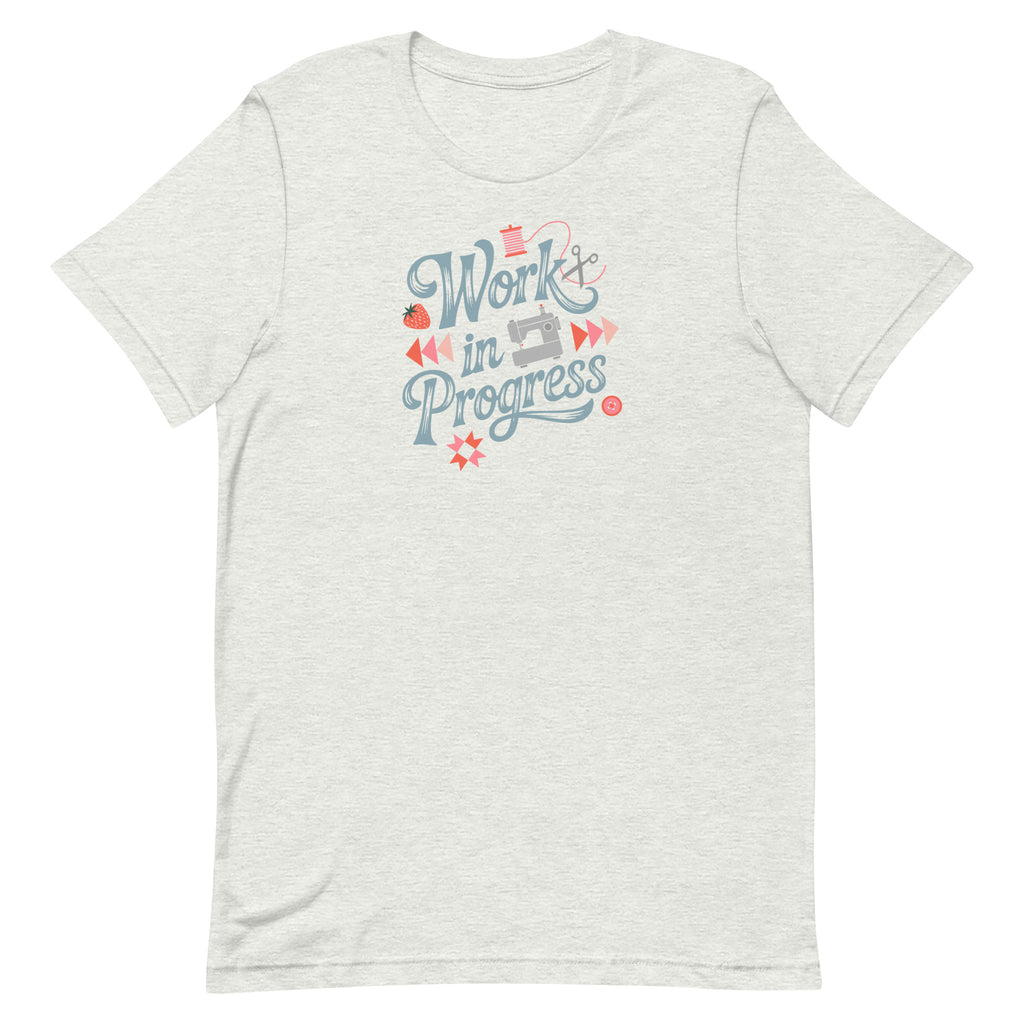 Work in Progress sewing design with flying geese, sewing machine, strawberry and thread spool on a t-shirt in ash, front view – Kate Spain design for Pat Sloan