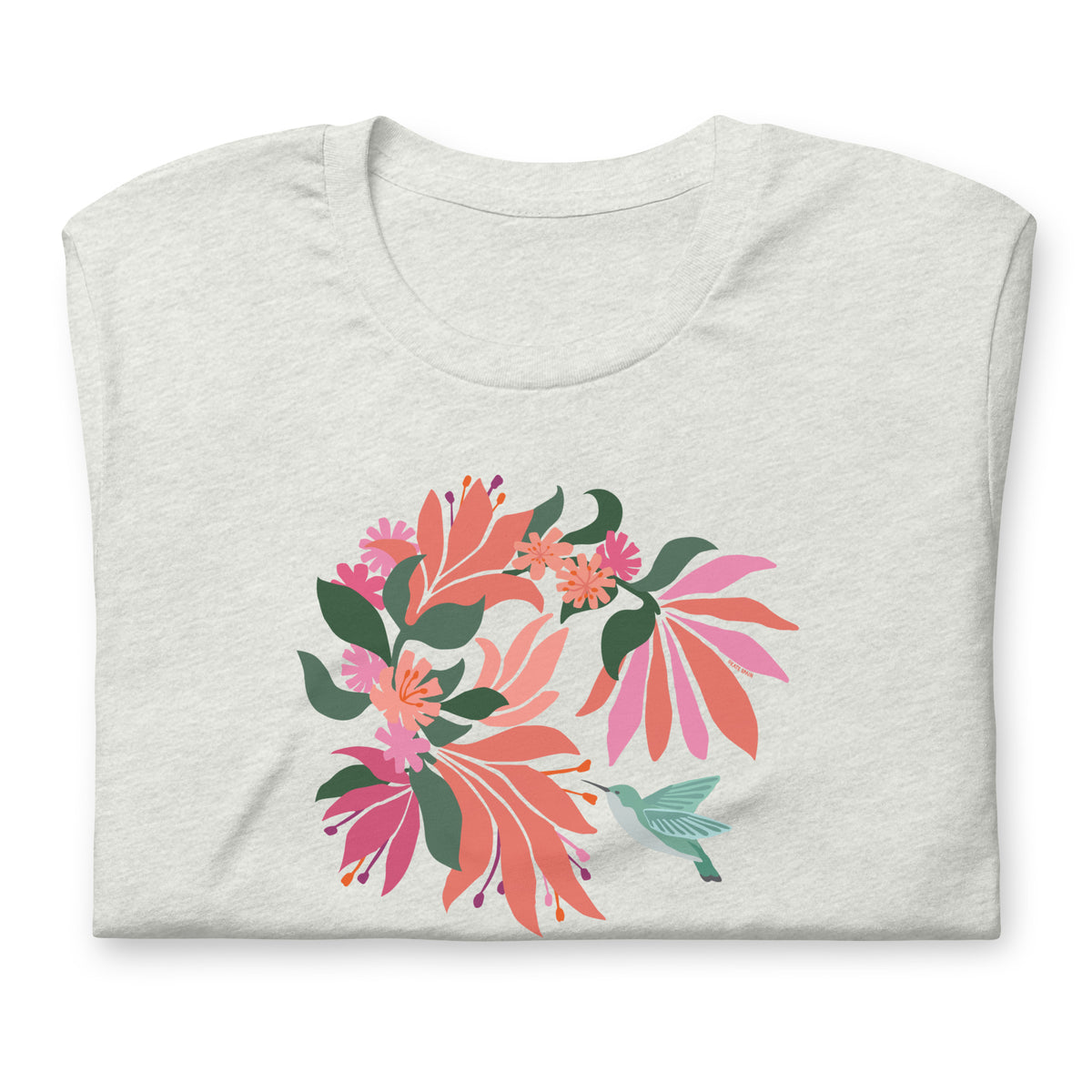 Hummingbird among coral tropical flowers on a t-shirt in ash, folded close-up of the design – Kate Spain design