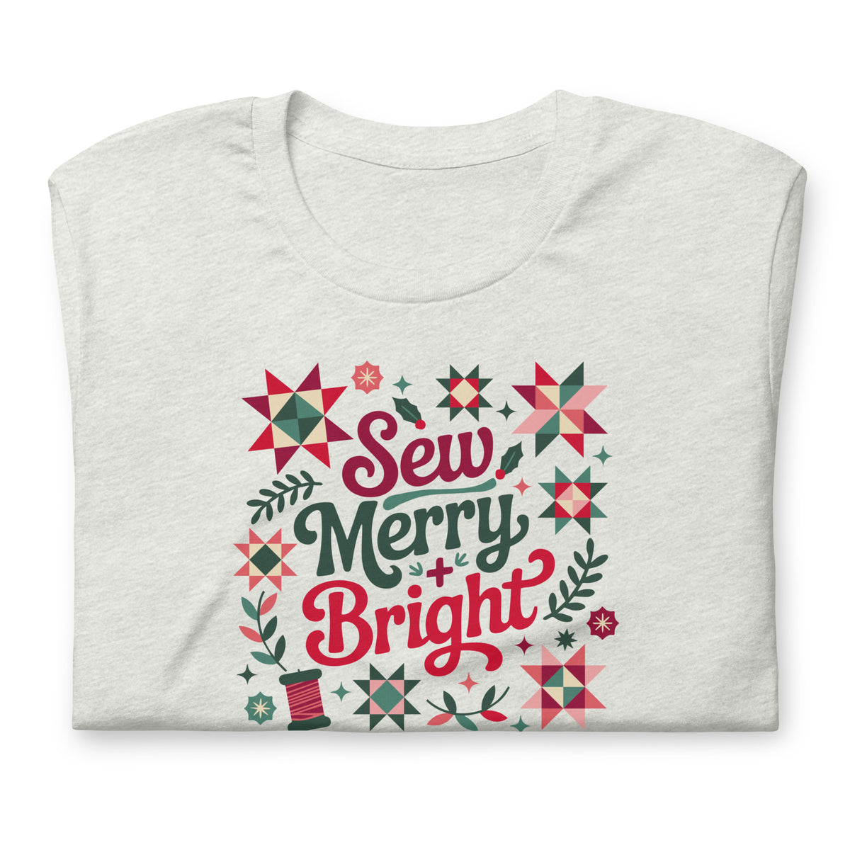 Sew Merry + Bright lettering with quilt stars and holly on a staple t-shirt in ash, folded close-up of the design – Kate Spain design for Pat Sloan