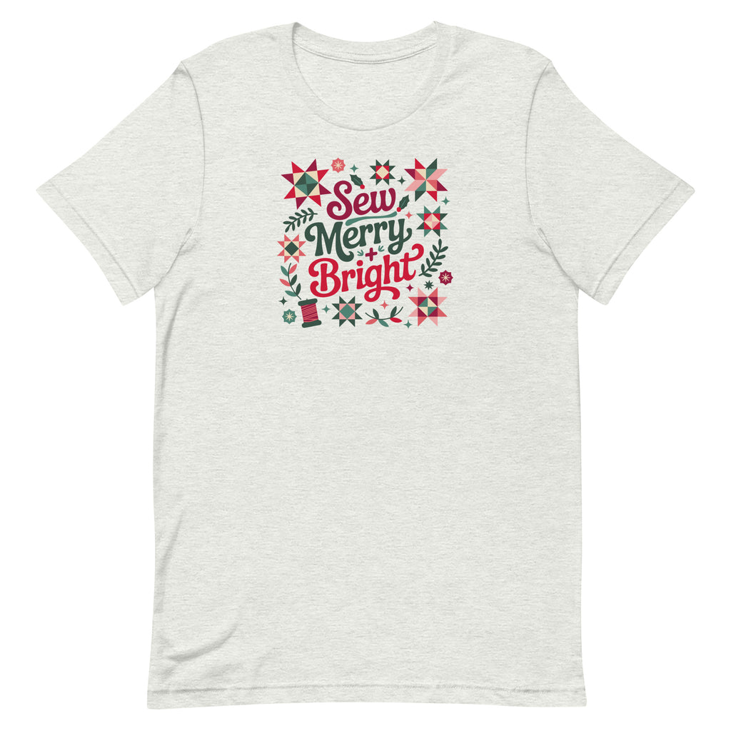 Sew Merry + Bright lettering with quilt stars and holly on a staple t-shirt in ash, front view – Kate Spain design for Pat Sloan