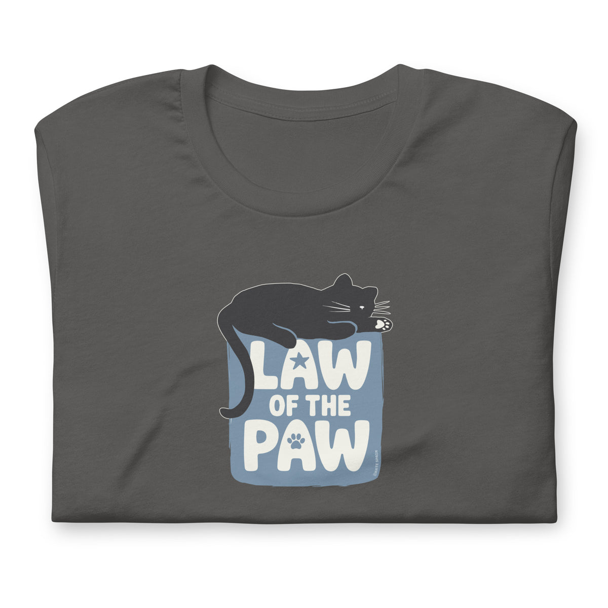 Law of the Paw® design with a cat napping on the logo on a t-shirt in asphalt, folded close-up of the design – Kate Spain design