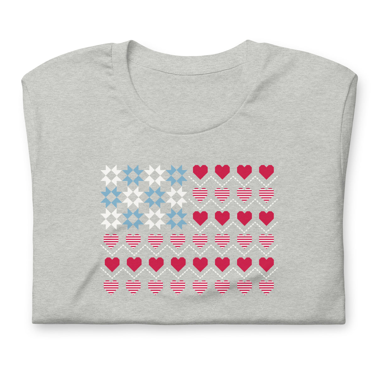 United We Quilt patchwork flag with quilt-block stars and heart stripes on a t-shirt in athletic heather grey, folded close-up of the design – Kate Spain design for Pat Sloan