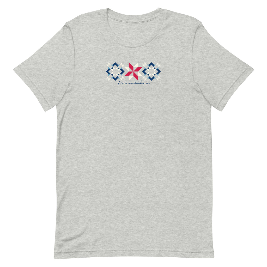 Firecracker quilt-block stars with script lettering in red, white and blue on a t-shirt in athletic heather grey, front view – Kate Spain design for Pat Sloan