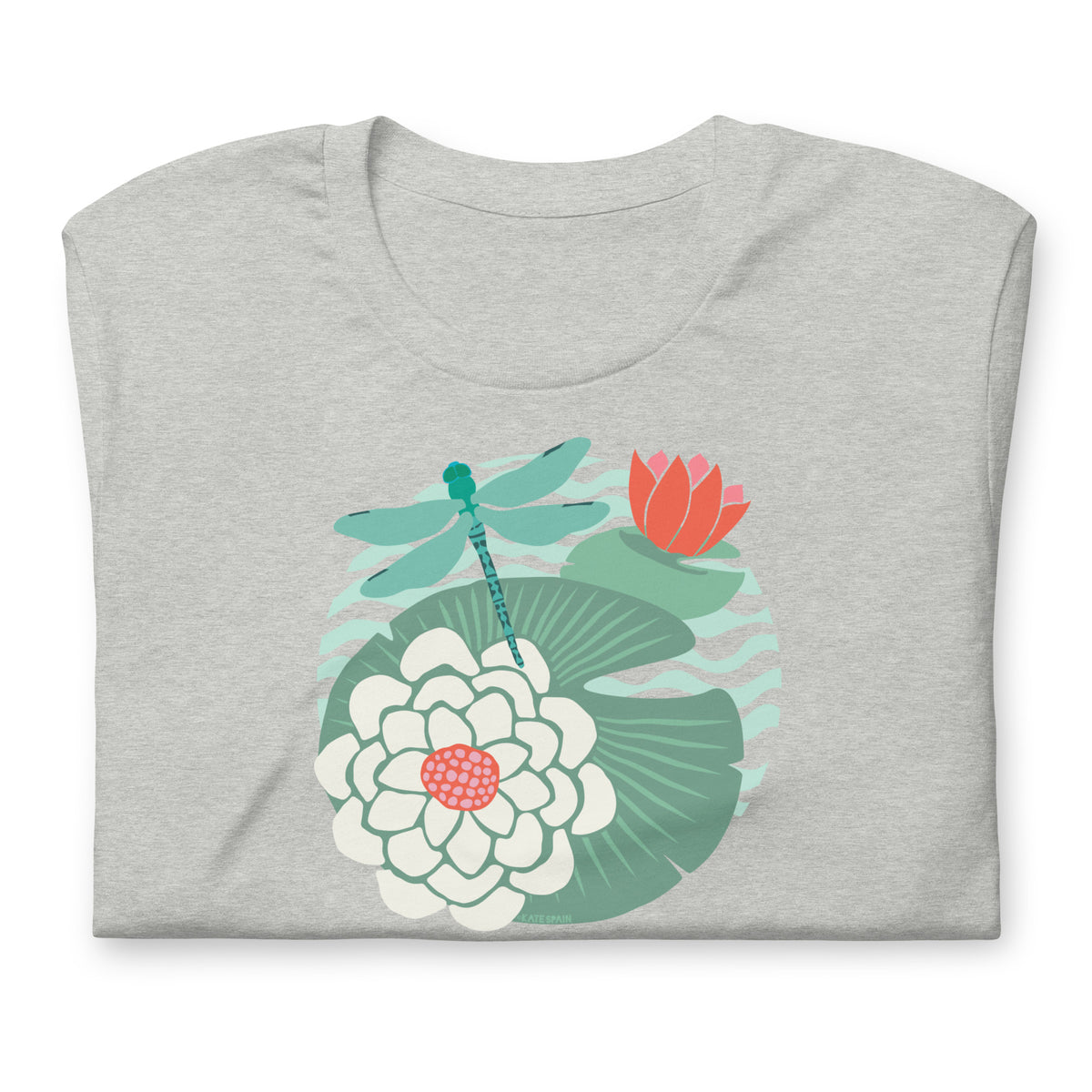 Dragonfly over water lilies and lily pads on a t-shirt in athletic heather grey, folded close-up of the design – Kate Spain design