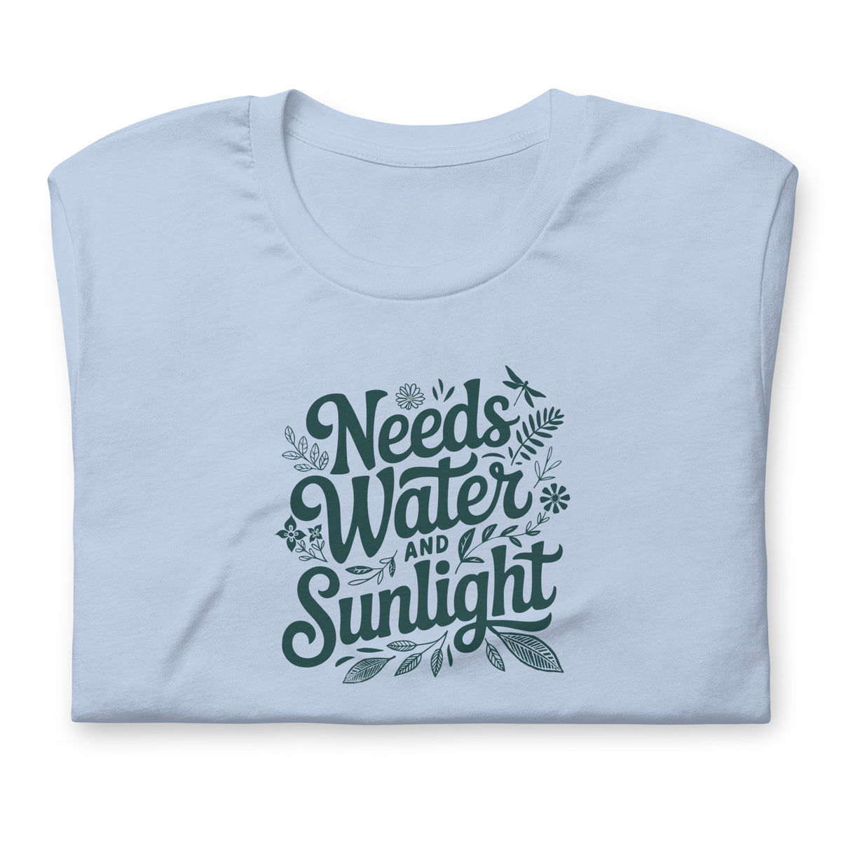 Needs Water + Sunlight hand lettering with leaf and sun accents on a t-shirt in light blue, folded close-up of the design – Kate Spain design