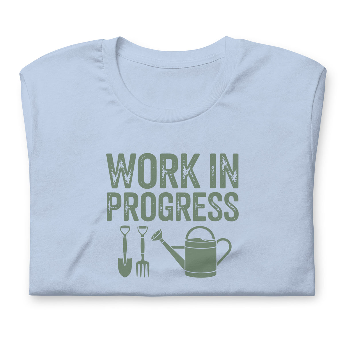 Garden Work in Progress distressed lettering with a shovel, pitchfork and watering can on a t-shirt in light blue, folded close-up of the design – Kate Spain design