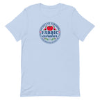 Fabric Curator Society of Stashers badge with a tomato pincushion on a t-shirt in light blue, front view – Kate Spain design for Pat Sloan