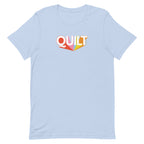 Moda QUILT logo with orange, pink, blue and yellow rays on a staple t-shirt in light blue, front view – Kate Spain design