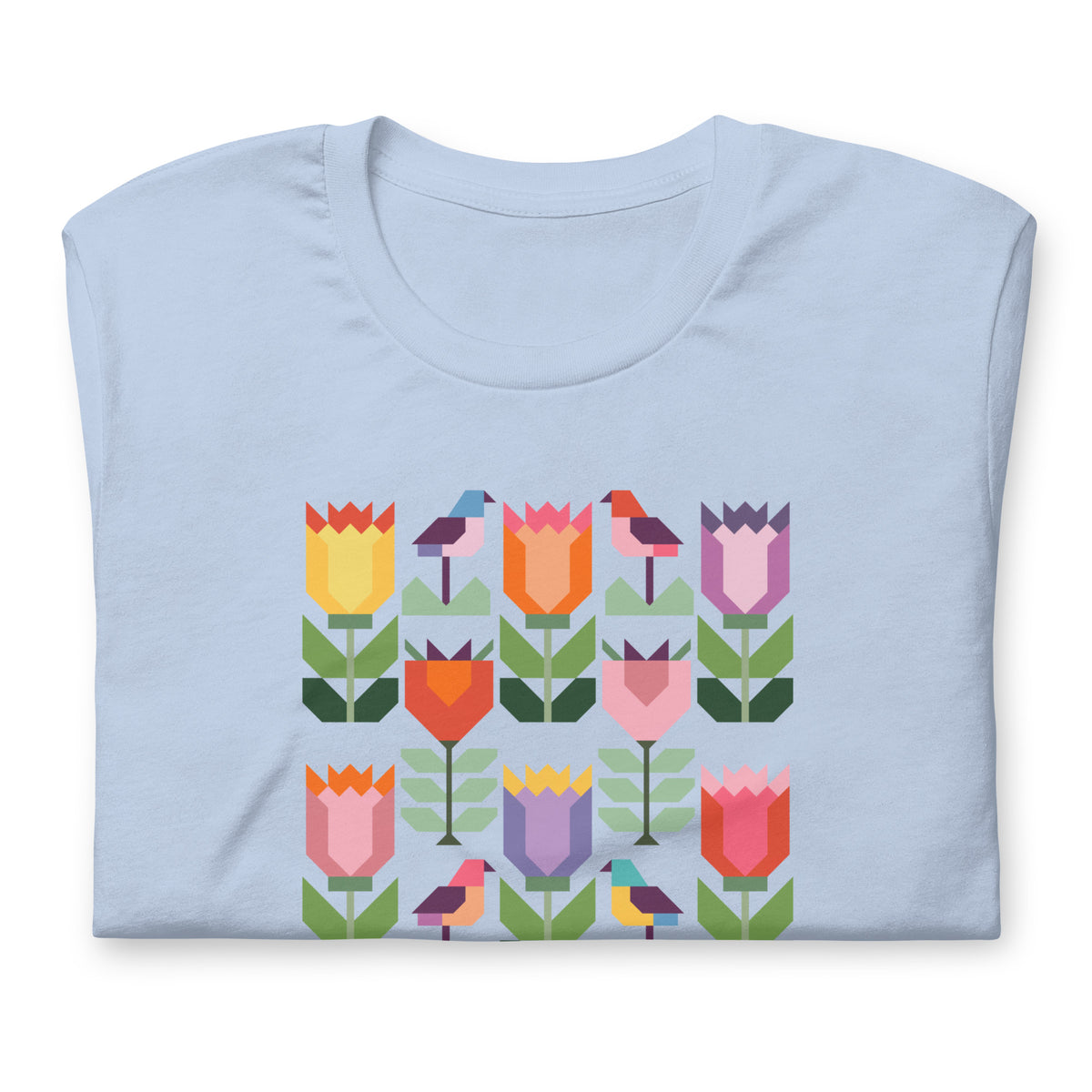 Birds + Blooms patchwork tulips and birds on a t-shirt in light blue, folded close-up of the design – Kate Spain design for Pat Sloan