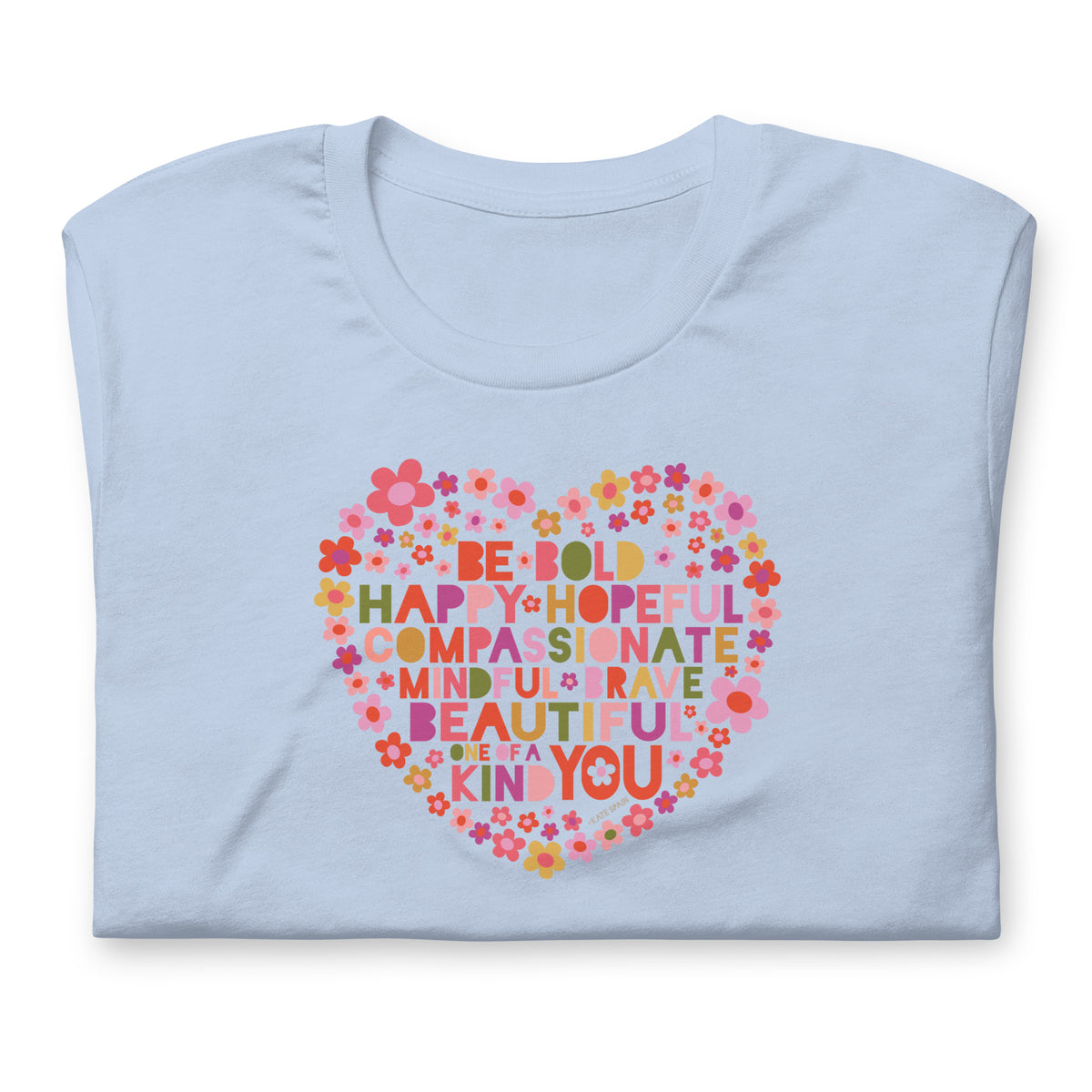 Be You floral heart of inspirational words on a staple t-shirt in baby blue, folded close-up of the design – Kate Spain design