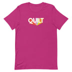 Moda QUILT logo with orange, pink, blue and yellow rays on a staple t-shirt in berry, front view – Kate Spain design