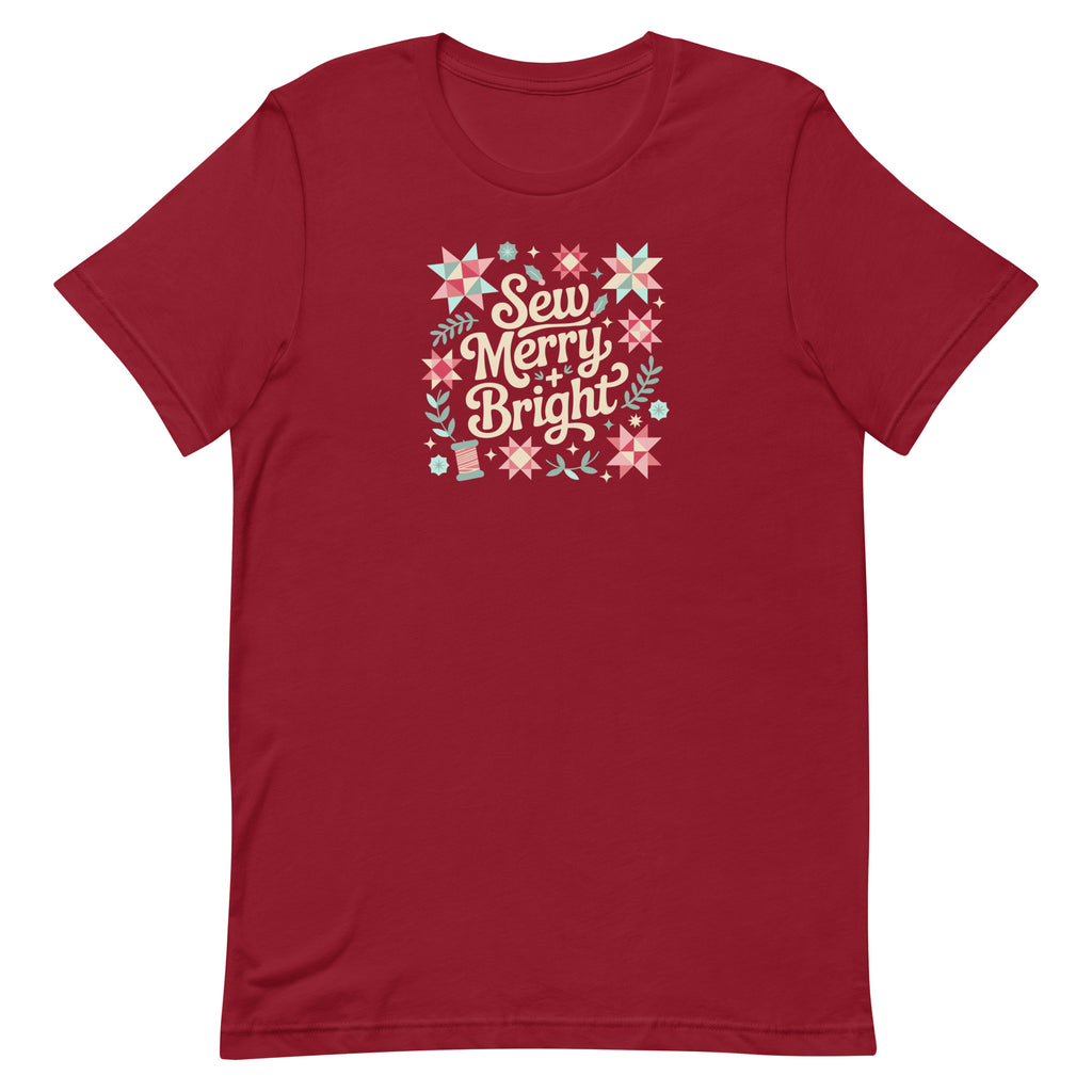Sew Merry + Bright lettering with quilt stars and holly on a staple t-shirt in cardinal red, front view – Kate Spain design for Pat Sloan