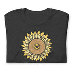 Golden sunflower with a heart center on a crewneck t-shirt in dark grey heather, folded close-up of the design – Sunflowers in My Heart by Kate Spain