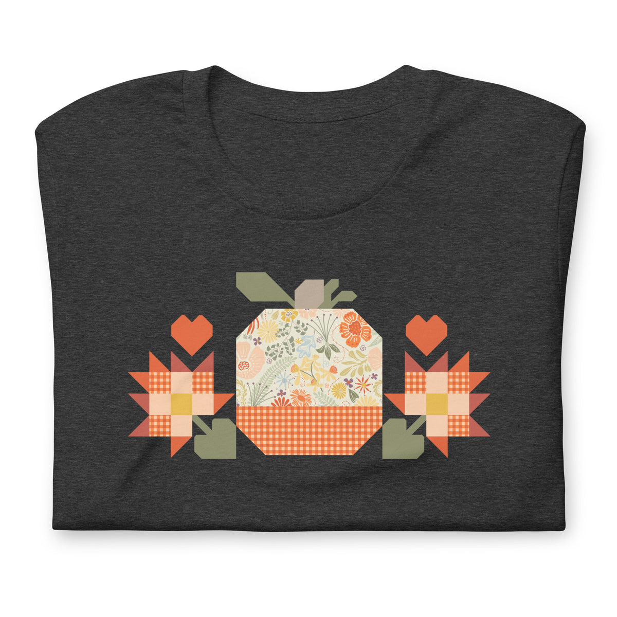 Falling for Fall patchwork pumpkin with quilt-block stars and hearts on a t-shirt in dark grey heather, folded close-up of the design – Kate Spain design for Pat Sloan