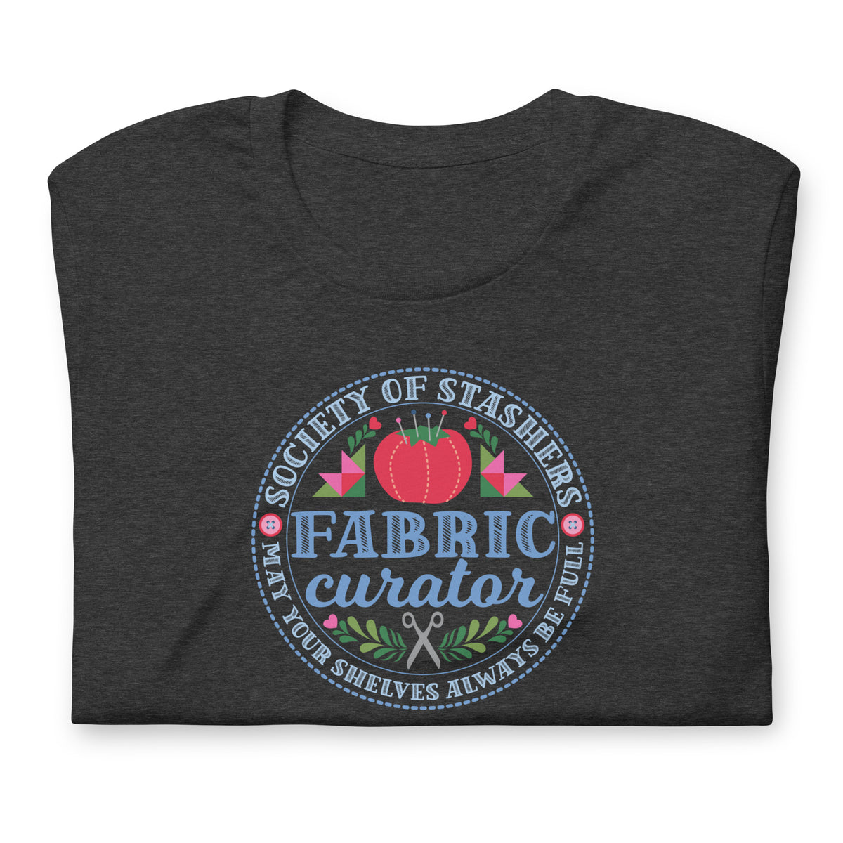Fabric Curator Society of Stashers badge with a tomato pincushion on a t-shirt in dark grey heather, folded close-up of the design – Kate Spain design for Pat Sloan